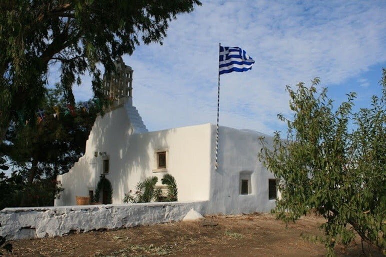 Paros, Marmara, Festival of Pera Panagia - Gastronomy Tours front of the church Pera Panagia commemorate festival of them at Paros, Marmara, Greece surrounded by trees
